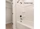 Clean, modern bathtub and shower with white subway tile at 1308 Walter Taylor Way # Eqx0105, Charlotte, NC 28206