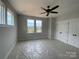 Light-filled bedroom with a ceiling fan, view from the windows, and spacious closet at 1308 Walter Taylor Way # Eqx0105, Charlotte, NC 28206