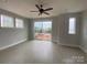Spacious bedroom featuring large windows offering outdoor views and a ceiling fan at 1308 Walter Taylor Way # Eqx0105, Charlotte, NC 28206