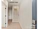 Bright hallway with hardwood floors, white walls, and staircase to the upper level at 1308 Walter Taylor Way # Eqx0105, Charlotte, NC 28206