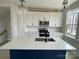 Modern kitchen with a navy island, white cabinets, quartz countertops, and stainless steel appliances at 1308 Walter Taylor Way # Eqx0105, Charlotte, NC 28206