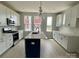 A modern kitchen features stainless steel appliances, bright white cabinets and herringbone backsplash tile at 1308 Walter Taylor Way # Eqx0105, Charlotte, NC 28206