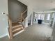 Open floor plan showcasing the staircase and kitchen with stainless appliances and plenty of cabinet space at 1308 Walter Taylor Way # Eqx0105, Charlotte, NC 28206