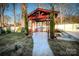 Landscaped backyard with red wooden gazebo at 152 Woodlynn Dr, Charlotte, NC 28214