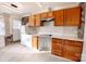 Modern kitchen with wood cabinets, white appliances, and marble countertops at 152 Woodlynn Dr, Charlotte, NC 28214