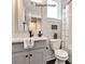 Modern bathroom with gray vanity, white toilet and shower at 1607 Polk St # Eqx0210, Charlotte, NC 28206