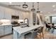 Modern kitchen with island, stainless steel appliances, and dining area view at 1607 Polk St # Eqx0210, Charlotte, NC 28206