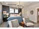 Main bedroom with an elegant chandelier and ensuite access at 1607 Polk St # Eqx0210, Charlotte, NC 28206