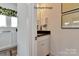 Small powder room with dark countertop and white cabinets at 1607 Polk St # Eqx0210, Charlotte, NC 28206