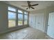 Bedroom with three large windows, a ceiling fan, and a closet, offering ample natural light at 1611 Polk St # Eqx0209, Charlotte, NC 28206