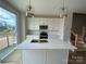Modern kitchen featuring white cabinets, a center island, stainless appliances, and stylish pendant lights at 1611 Polk St # Eqx0209, Charlotte, NC 28206
