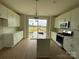 Spacious kitchen with white cabinets, stainless appliances, a large island, and hardwood floors at 1611 Polk St # Eqx0209, Charlotte, NC 28206