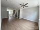 Bright living room features hardwood floors, a ceiling fan, and stairs to the upper level at 1611 Polk St # Eqx0209, Charlotte, NC 28206