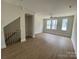 Bright living room with hardwood floors, ceiling fan, and large windows that fill the space with natural light at 1611 Polk St # Eqx0209, Charlotte, NC 28206