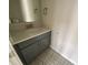 Charming powder room with patterned tile flooring, gray cabinets, and elegant fixtures at 1611 Polk St # Eqx0209, Charlotte, NC 28206