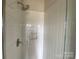 Bathroom shower with white subway tile, a built-in niche, and chrome fixtures at 1611 Polk St # Eqx0209, Charlotte, NC 28206