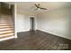 Bedroom boasts hardwood floors, stairs to the upper level, and a modern ceiling fan at 1615 Polk St # Eqx0208, Charlotte, NC 28206