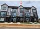 Modern townhome with brick facade, balcony, and neutral color scheme offers contemporary living at 1615 Polk St # Eqx0208, Charlotte, NC 28206