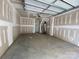 An unfinished two-car garage featuring an automatic door and hot water heater at 1615 Polk St # Eqx0208, Charlotte, NC 28206
