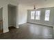 Bright, open living room features hardwood floors and three large windows at 1615 Polk St # Eqx0208, Charlotte, NC 28206