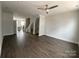 Bright living room with hardwood floors, a ceiling fan, and stairs to the upper level at 1615 Polk St # Eqx0208, Charlotte, NC 28206