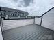 Rooftop deck on townhome showing neutral gray color scheme and partial view at 1615 Polk St # Eqx0208, Charlotte, NC 28206