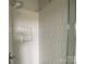 Modern shower features white subway tile, a rainfall showerhead, and built-in shelving at 1615 Polk St # Eqx0208, Charlotte, NC 28206