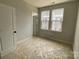 This bedroom has two windows for natural light and a neutral color palette at 1619 Polk St # Eqx0207, Charlotte, NC 28206