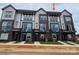 Newly constructed townhomes featuring modern architecture and a mix of brick and siding accents at 1619 Polk St # Eqx0207, Charlotte, NC 28206