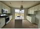 Modern kitchen with stainless appliances, white shaker cabinets and an island with bar seating at 1619 Polk St # Eqx0207, Charlotte, NC 28206