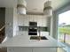 Modern kitchen with stainless appliances, quartz counters and an island with designer pendant lighting at 1619 Polk St # Eqx0207, Charlotte, NC 28206