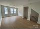 Bright living room featuring large windows, hardwood floors, and an open floor plan at 1619 Polk St # Eqx0207, Charlotte, NC 28206