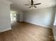 Spacious living room features hardwood floors, ceiling fan, and neutral paint colors at 1619 Polk St # Eqx0207, Charlotte, NC 28206