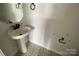 Small pedestal sink in bathroom with stylish tile floor at 1619 Polk St # Eqx0207, Charlotte, NC 28206