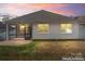 House exterior with screened porch and brick patio at dusk at 2491 Seagull Dr, Denver, NC 28037