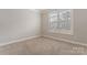 Well-lit bedroom with neutral walls and carpet flooring at 2491 Seagull Dr, Denver, NC 28037