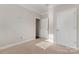 Well-lit bedroom with neutral carpeting and ample closet space at 2491 Seagull Dr, Denver, NC 28037