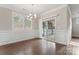 Dining room with hardwood floors, sliding door to patio, and wainscoting at 2491 Seagull Dr, Denver, NC 28037