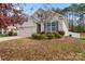 Tan house with a two-car garage, landscaping, and a white fence at 2491 Seagull Dr, Denver, NC 28037