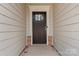 Dark brown front door with sidelights and a stone base at 2491 Seagull Dr, Denver, NC 28037