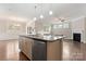 Modern kitchen island with granite countertops and stainless steel appliances at 2491 Seagull Dr, Denver, NC 28037