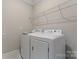 Bright laundry room, featuring washer, dryer, and ample shelving at 2491 Seagull Dr, Denver, NC 28037