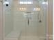 Spacious shower with glass enclosure, tiled walls, and built-in seat at 2491 Seagull Dr, Denver, NC 28037