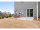 Small patio adjacent to the back door of a townhome with access to yard at 2795 Yeager Nw Dr, Concord, NC 28027