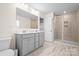 Main bathroom with double vanity, gray cabinets and shower at 2795 Yeager Nw Dr, Concord, NC 28027