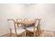 Bright dining area with light wood table and six white cushioned chairs at 2795 Yeager Nw Dr, Concord, NC 28027