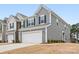 Gray townhome with two-car garage, landscaping, and a modern design at 2795 Yeager Nw Dr, Concord, NC 28027