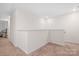 Upstairs hallway with neutral walls and carpet at 2795 Yeager Nw Dr, Concord, NC 28027