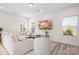 Living room with off-white sofa and chairs, hardwood floors, and large TV at 2795 Yeager Nw Dr, Concord, NC 28027