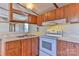 Kitchen area with wood cabinets and white appliances at 3586 Bridle Path Dr, Vale, NC 28168